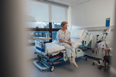 Woman sitting in hospital bed